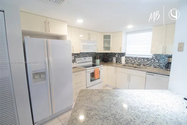 a kitchen with stainless steel appliances a refrigerator and a stove top oven