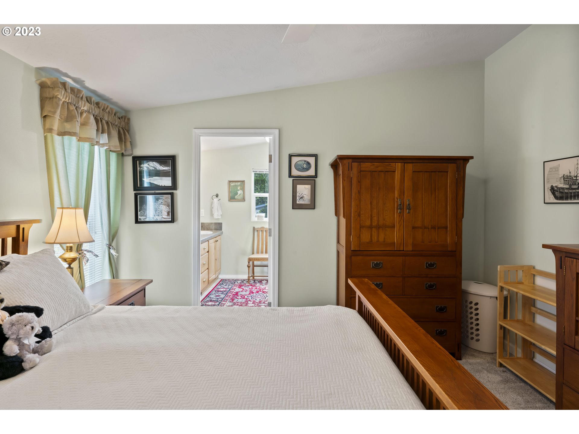 175 Florentine Avenue Florence, OR 97439 - Photo 15 of 27 a bedroom with a bed and wooden floor