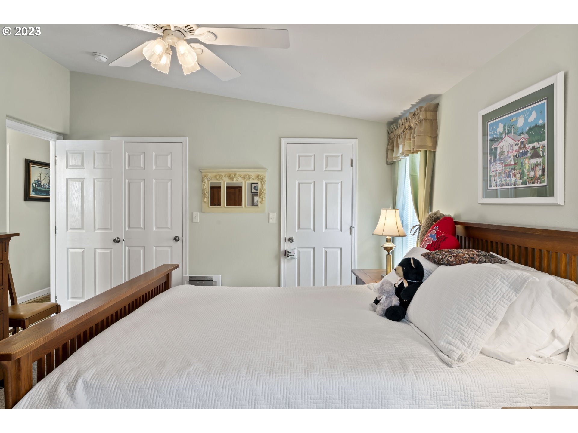 175 Florentine Avenue Florence, OR 97439 - Photo 16 of 27 a bedroom with a bed and a chandelier