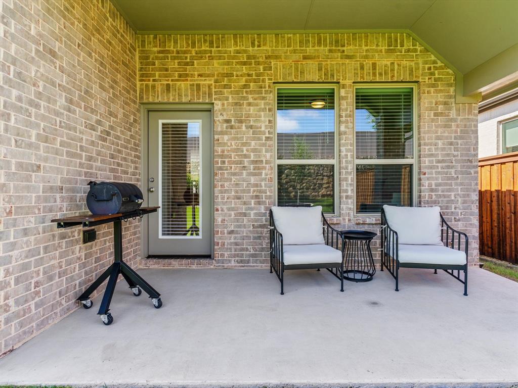 166 Palo Duro Bend Rhome, TX 76078 - Photo 34 of 40 Covered patio overlooking the backyard, ideal for outdoor relaxation.