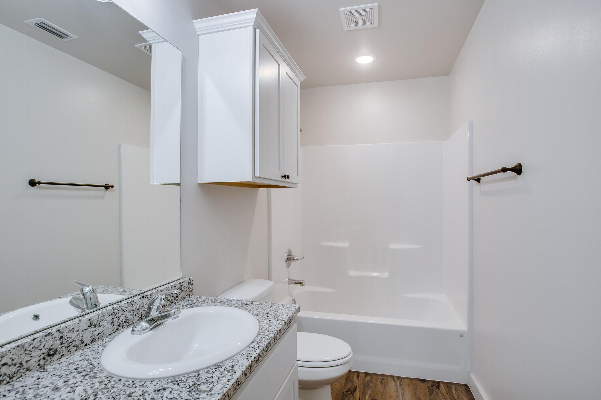 5515 121st Street, Unit B Lubbock, TX 79424 - Photo 13 of 15 a bathroom with a sink a toilet and shower