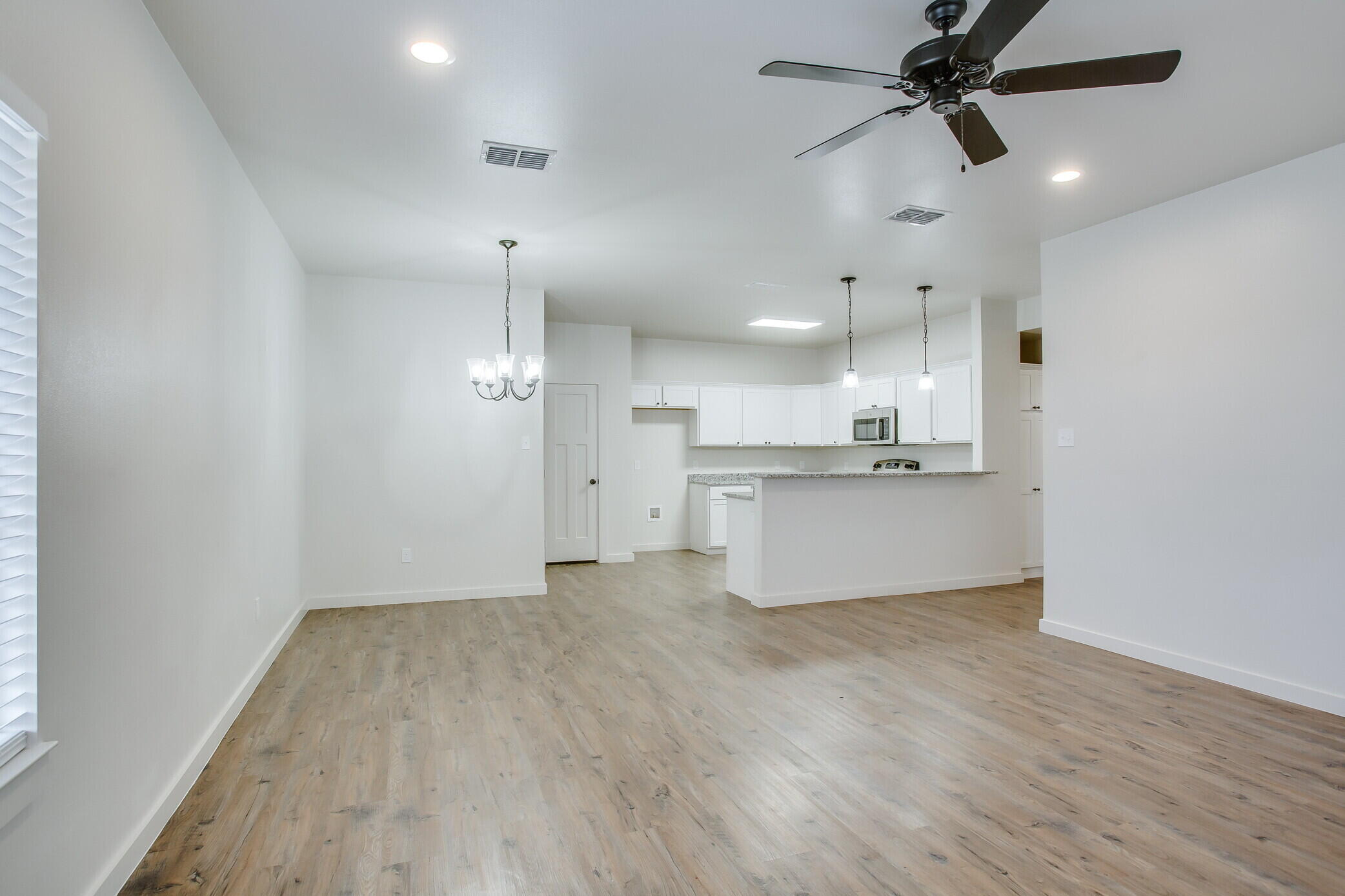 5515 121st Street, Unit B Lubbock, TX 79424 - Photo 2 of 15 a view of a kitchen with a sink and wooden floor