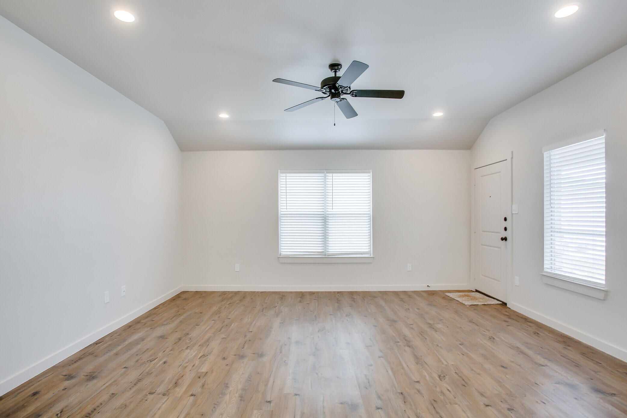 5515 121st Street, Unit B Lubbock, TX 79424 - Photo 4 of 15 a view of empty room with wooden floor and fan