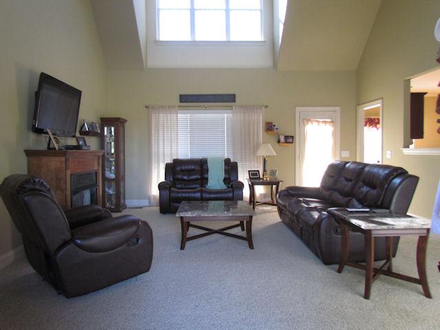 3676 Big Springs Road Lebanon, TN 37090 - Photo 3 of 20 The living room has carpet, an 18' ceiling and an exterior door leading out to the covered back porch.