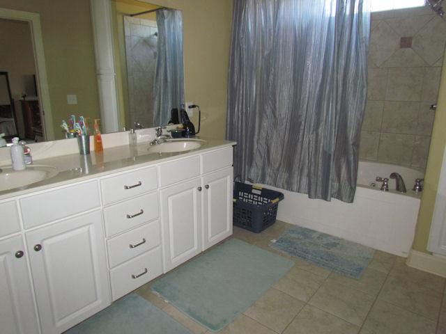 3676 Big Springs Road Lebanon, TN 37090 - Photo 7 of 20 The master bath has a double vanity and a custom tile shower with a whrilpool tub combo.