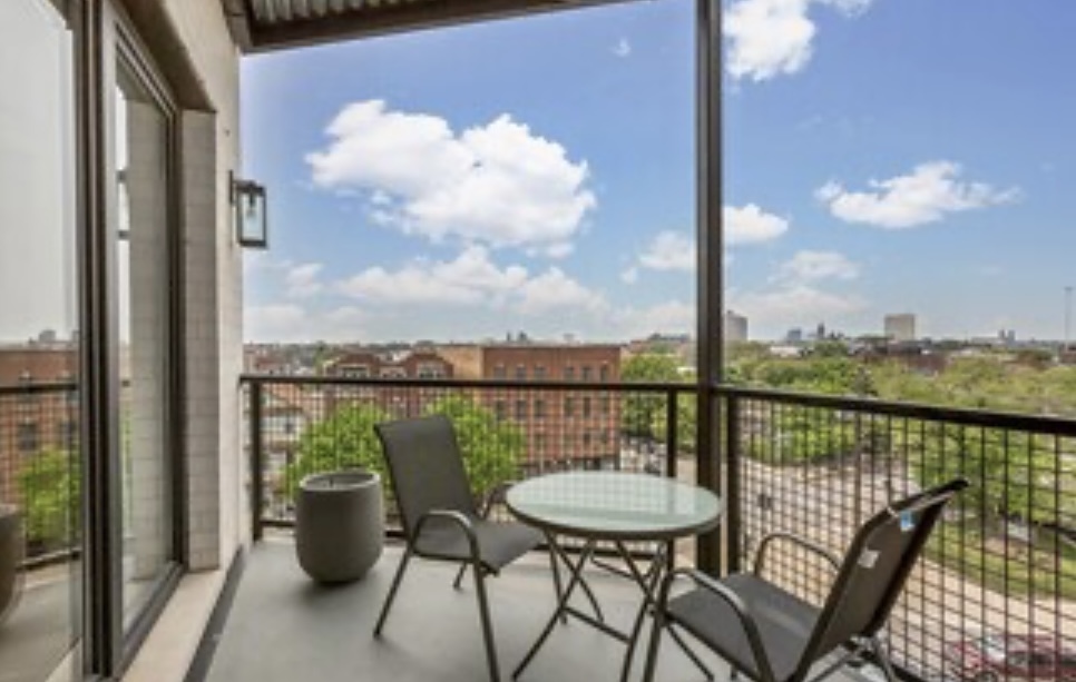 1157 West Erie Street, Unit 5W Chicago, IL 60642 - Photo 17 of 30 a view of a balcony with two chairs and a table