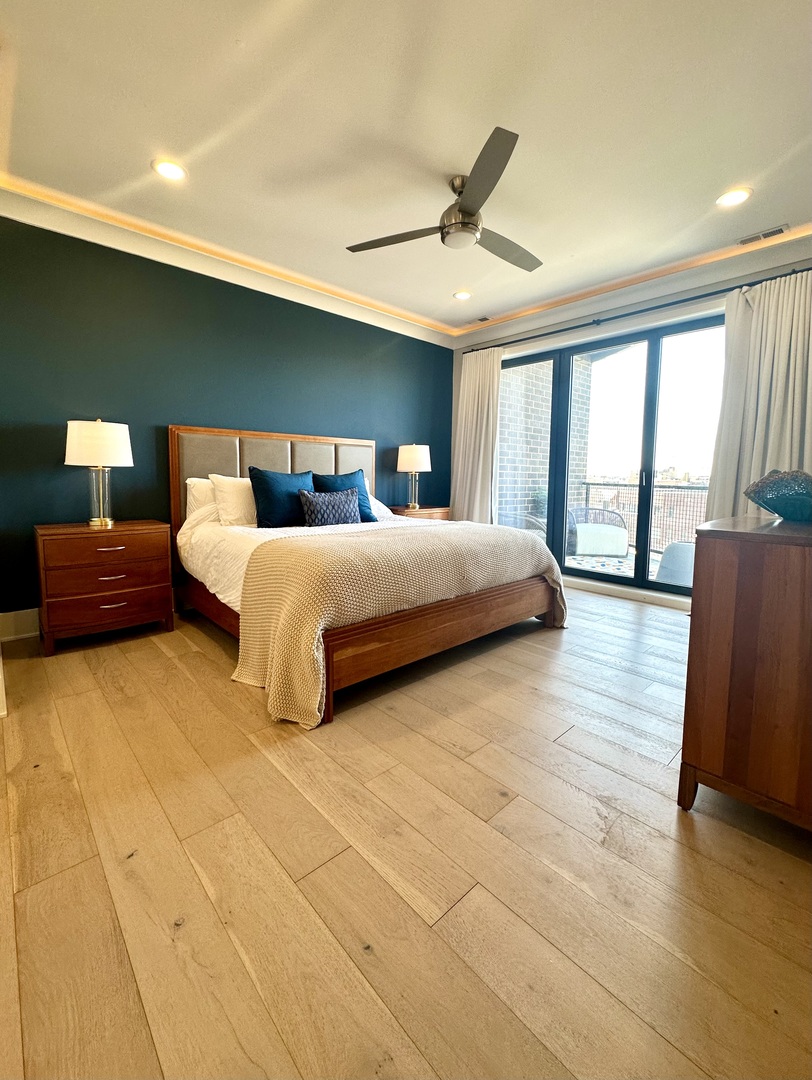 1157 West Erie Street, Unit 5W Chicago, IL 60642 - Photo 18 of 30 a bedroom with a large bed and a large window