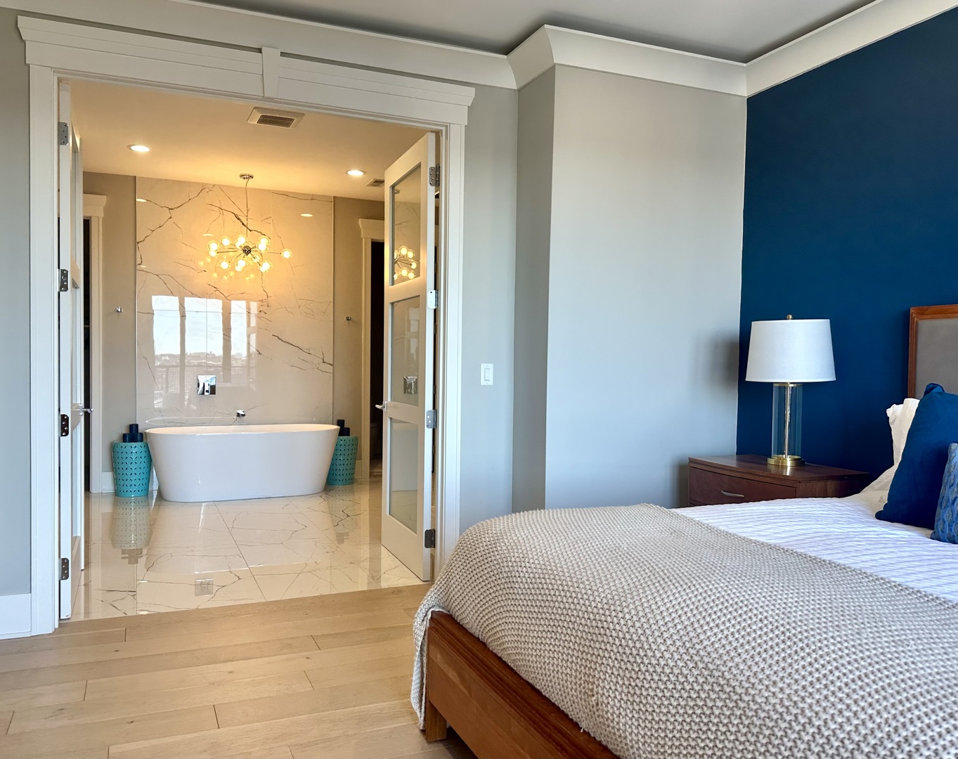 1157 West Erie Street, Unit 5W Chicago, IL 60642 - Photo 20 of 30 a bedroom with a bed and a lamp