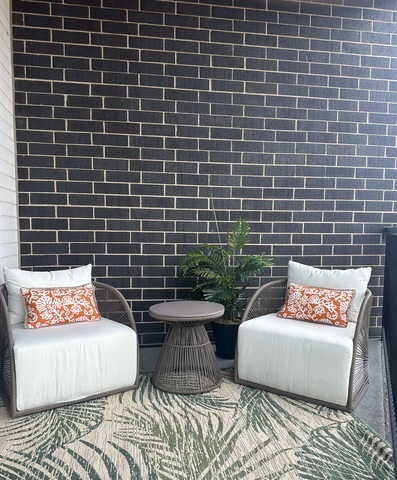 1157 West Erie Street, Unit 5W Chicago, IL 60642 - Photo 24 of 30 a outdoor sitting area with a couch