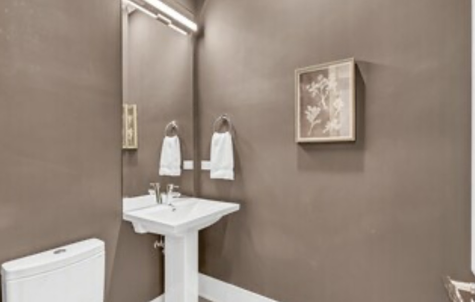 1157 West Erie Street, Unit 5W Chicago, IL 60642 - Photo 28 of 30 a bathroom with a sink a mirror and a toilet