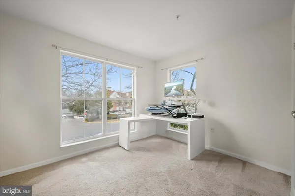 a view of empty room with a kitchen