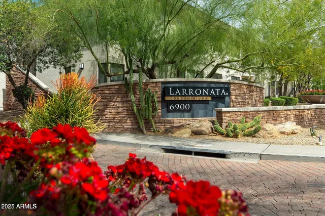 a sign that is sitting in front of flowers