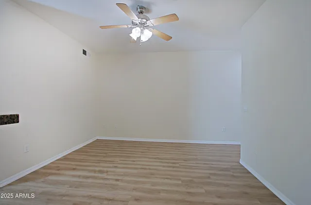 a view of kitchen with closet and wooden floor
