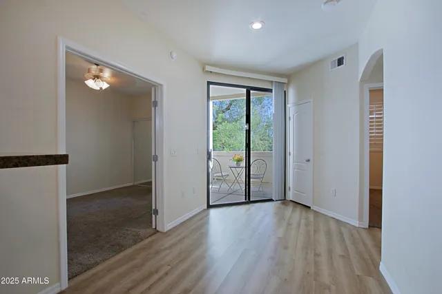 a view of a kitchen with wooden floor and a sink