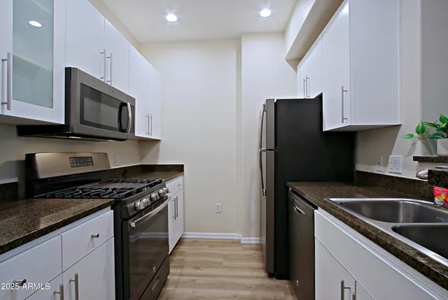 a stove top oven sitting inside of a kitchen