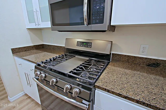 a kitchen with a refrigerator sink and window