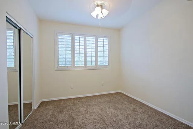 a bathroom with a granite countertop sink a light fixture and a mirror