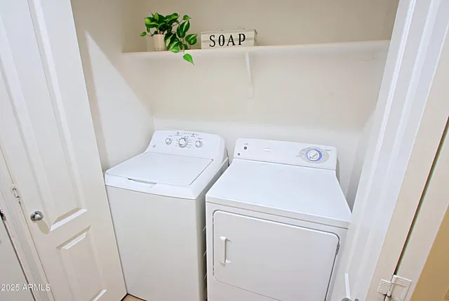 a patio with a table and chairs under an umbrella