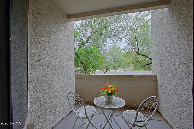 a view of a house with swimming pool and sitting area