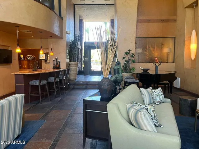 a living room with furniture a large window with kitchen view