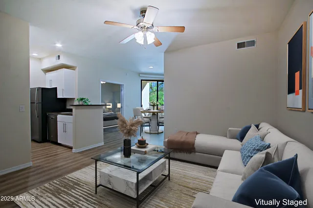 a view of a kitchen with a sink and a refrigerator