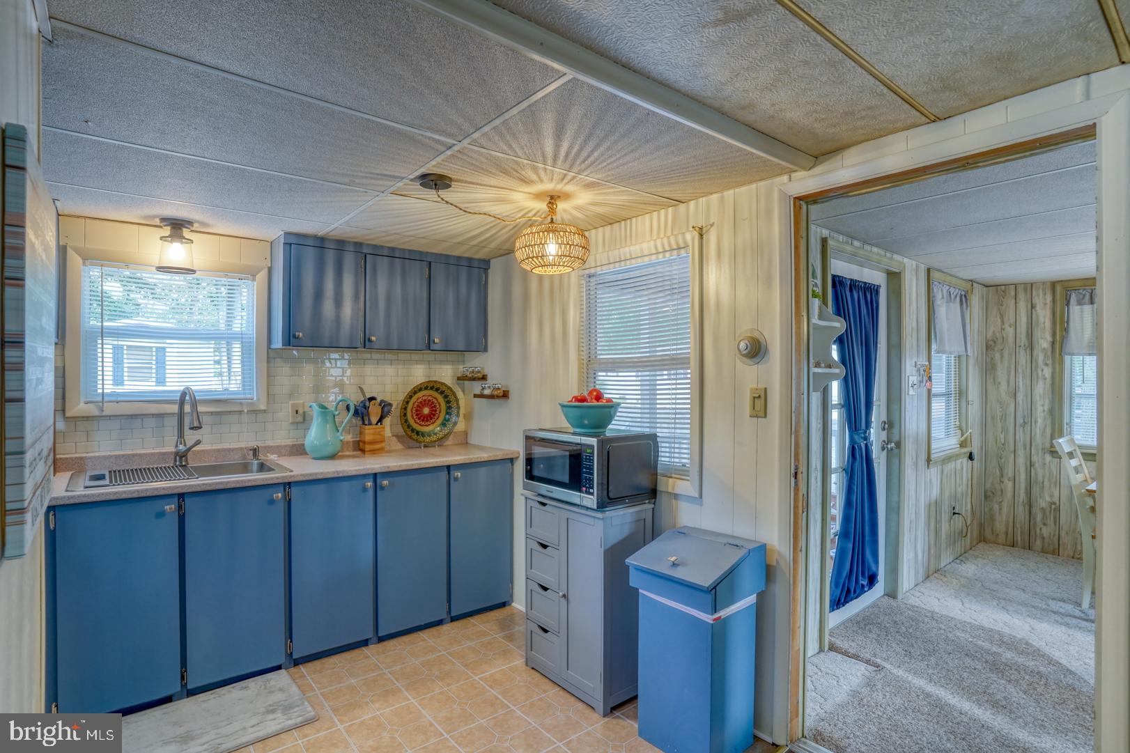 25780 Blue Ridge Street, Unit 4198 Millsboro, DE 19966 - Photo 22 of 36 a kitchen with a refrigerator and a sink