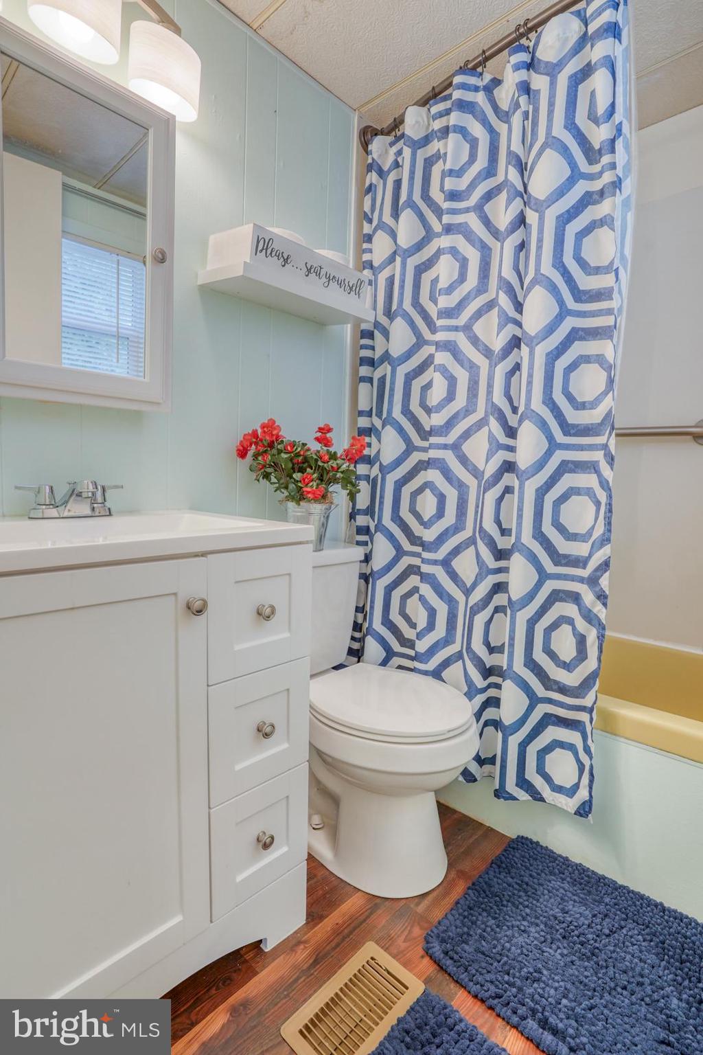 25780 Blue Ridge Street, Unit 4198 Millsboro, DE 19966 - Photo 30 of 36 a bathroom with a toilet sink and mirror