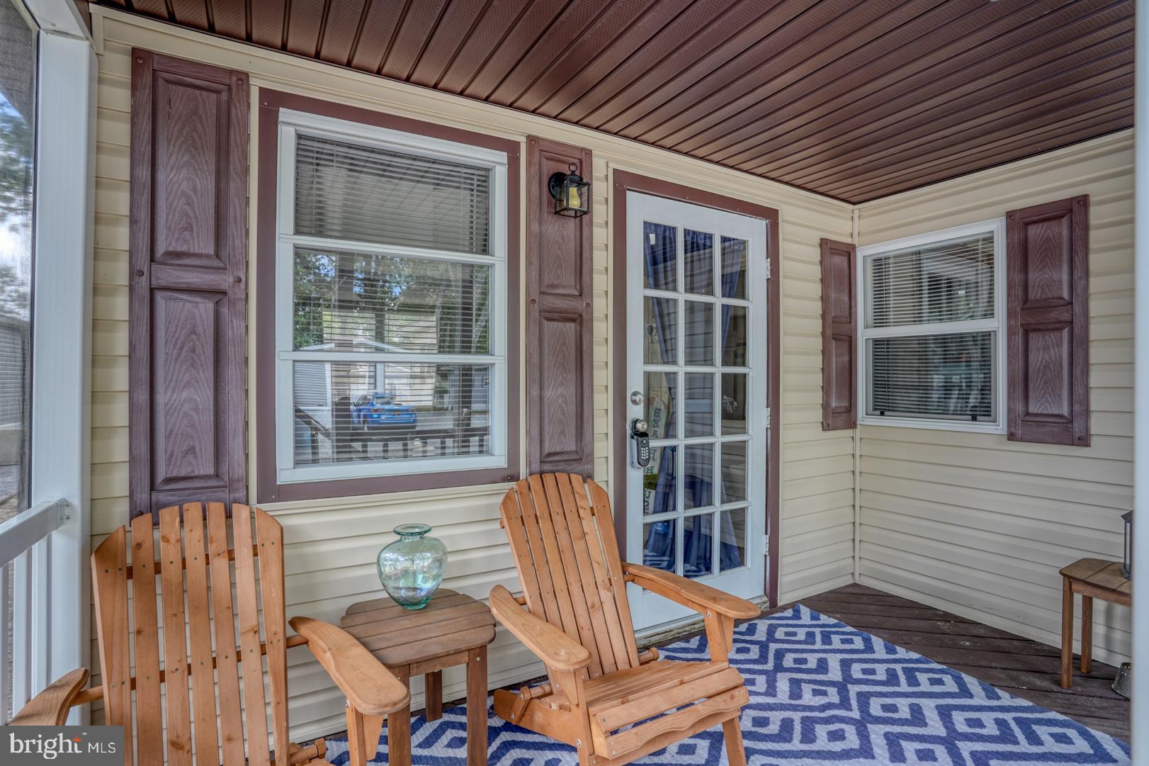 25780 Blue Ridge Street, Unit 4198 Millsboro, DE 19966 - Photo 31 of 36 a view of a deck with table and chairs and wooden floor