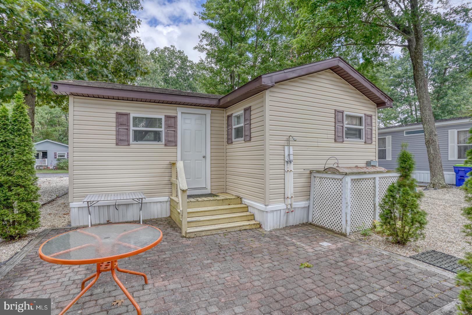 25780 Blue Ridge Street, Unit 4198 Millsboro, DE 19966 - Photo 32 of 36 a view of a house with backyard and chairs