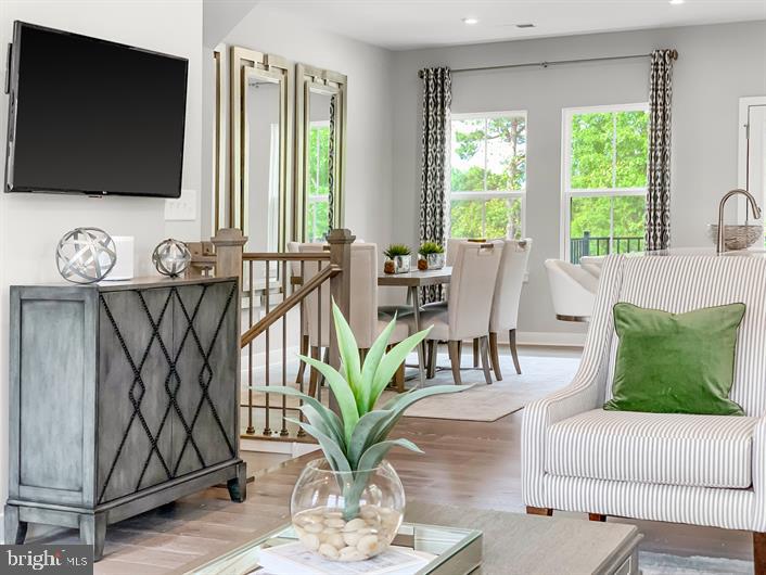 19756 Canopy Loop, Unit 328D Montgomery Village, MD 20886 - Photo 12 of 27 a living room with furniture and a flat screen tv