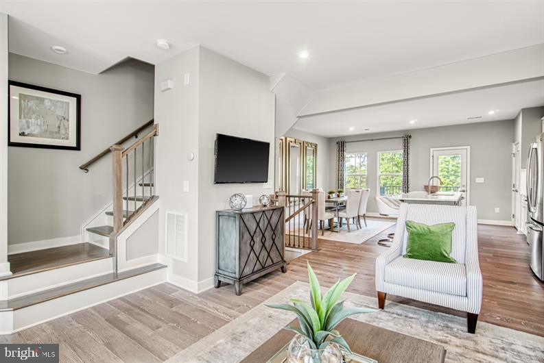 19756 Canopy Loop, Unit 328D Montgomery Village, MD 20886 - Photo 15 of 27 a living room with furniture and a flat screen tv