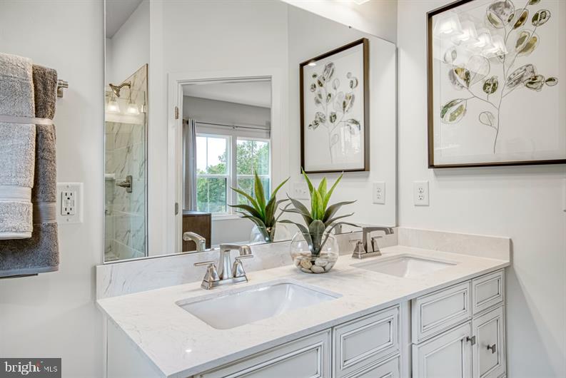 19756 Canopy Loop, Unit 328D Montgomery Village, MD 20886 - Photo 21 of 27 a bathroom with a sink and a mirror