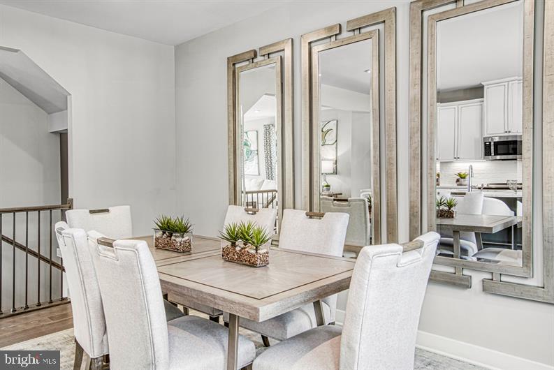 19756 Canopy Loop, Unit 328D Montgomery Village, MD 20886 - Photo 8 of 27 a view of a dining room with furniture and a potted plant