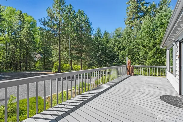 a view of balcony with wooden floor and fence