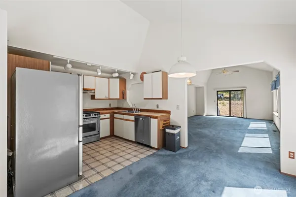 a kitchen with a refrigerator and a stove