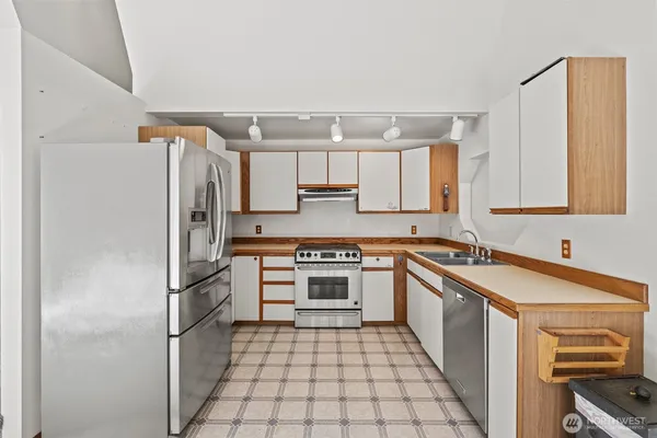 a kitchen with a sink cabinets and a window