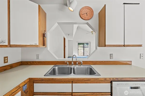 an empty room with windows and cabinet