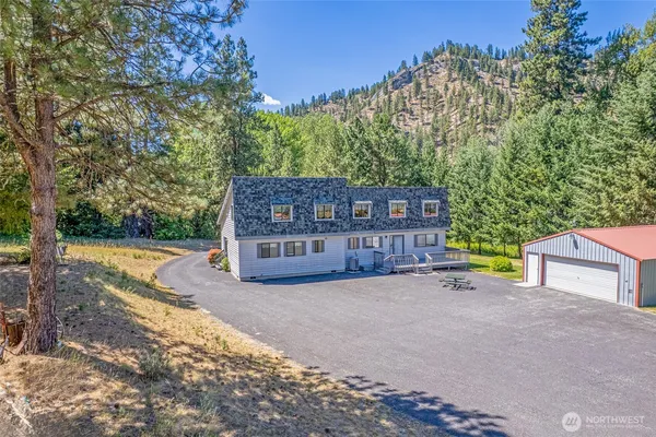 a view of a house with a yard and pathway
