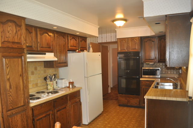 968 Hillcrest Road Elgin, IL 60123 - Photo 4 of 13 a kitchen with a sink a refrigerator and cabinets