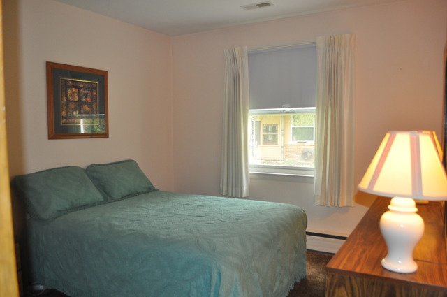 968 Hillcrest Road Elgin, IL 60123 - Photo 8 of 13 a bedroom with a bed and window