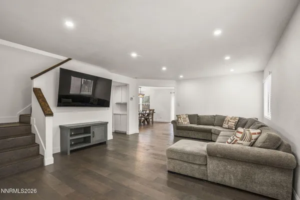 a living room with furniture fireplace and flat screen tv
