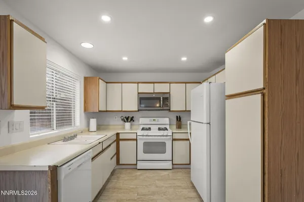 a kitchen with stainless steel appliances a stove a sink and a refrigerator