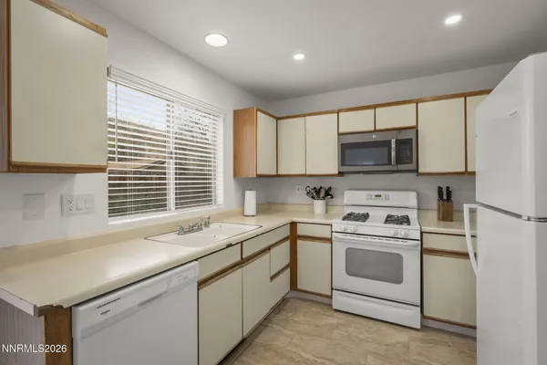 a kitchen with kitchen island a sink stove and microwave