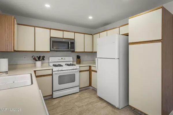 a white refrigerator freezer sitting in a kitchen