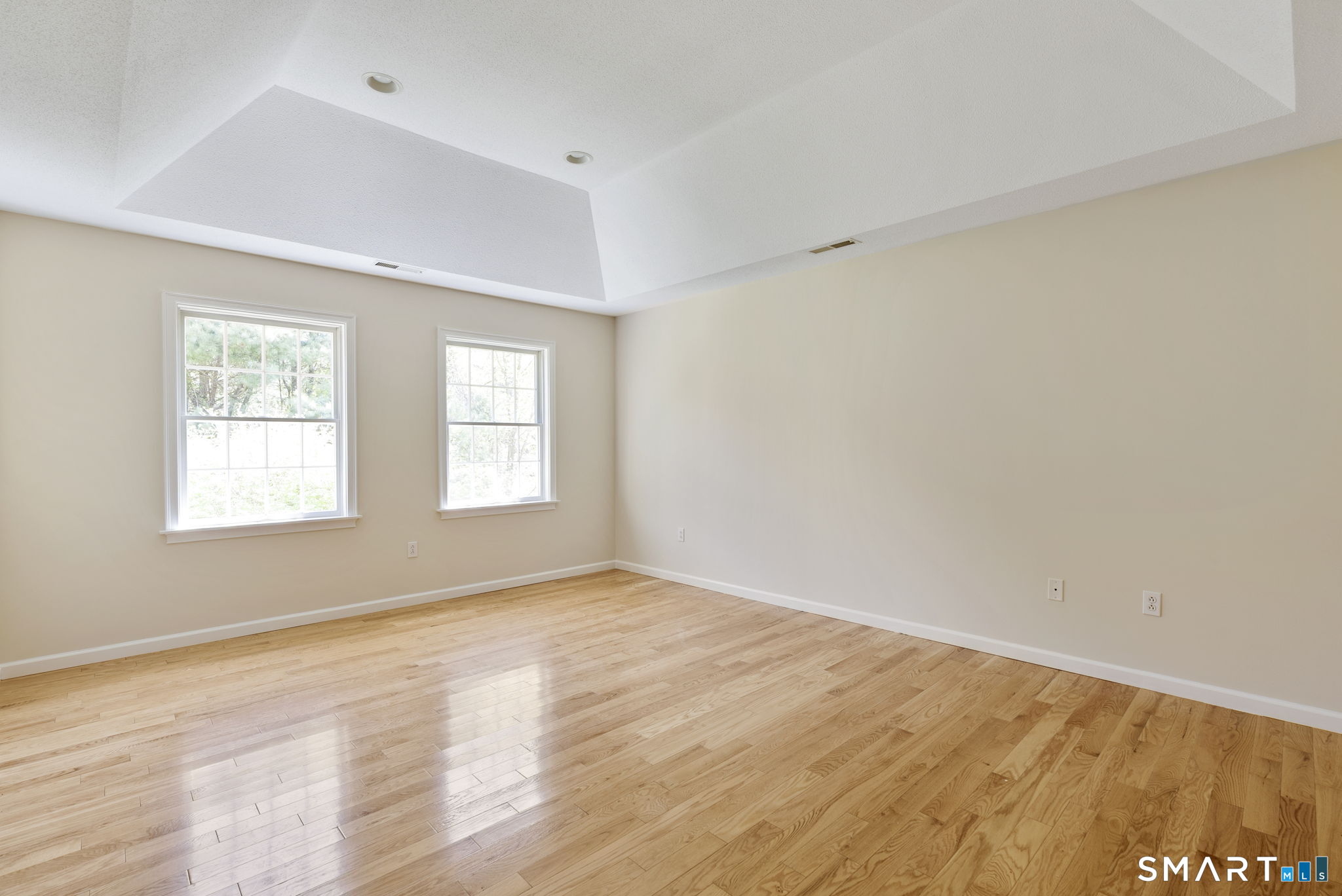 555 Waterville Road Avon, CT 06001 - Photo 30 of 40 an empty room with wooden floor and windows