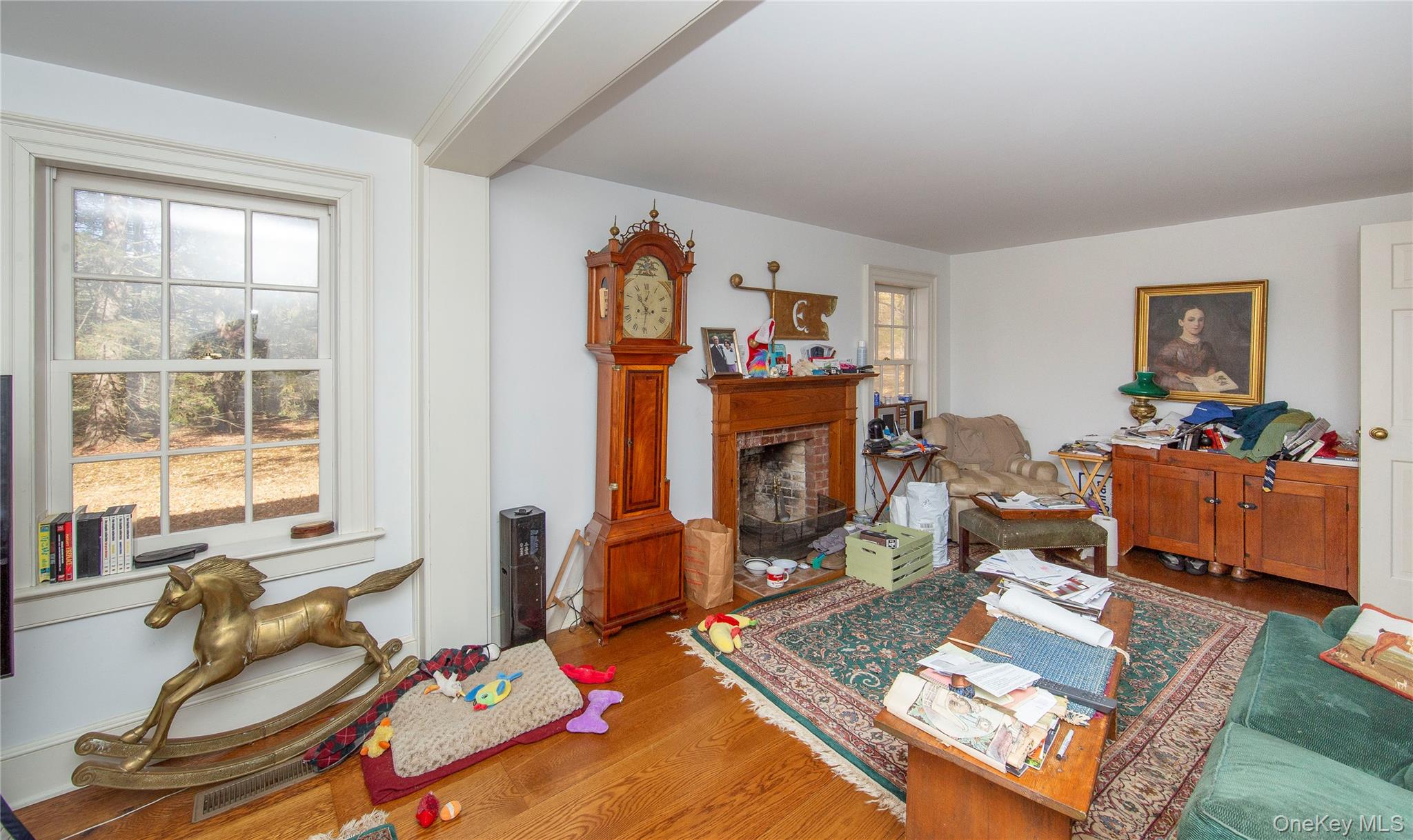 64 South Quaker Hill Road Pawling, NY 12564 - Photo 23 of 41 Hardwood flooring throughout a room featuring a brick fireplace with a wood mantel