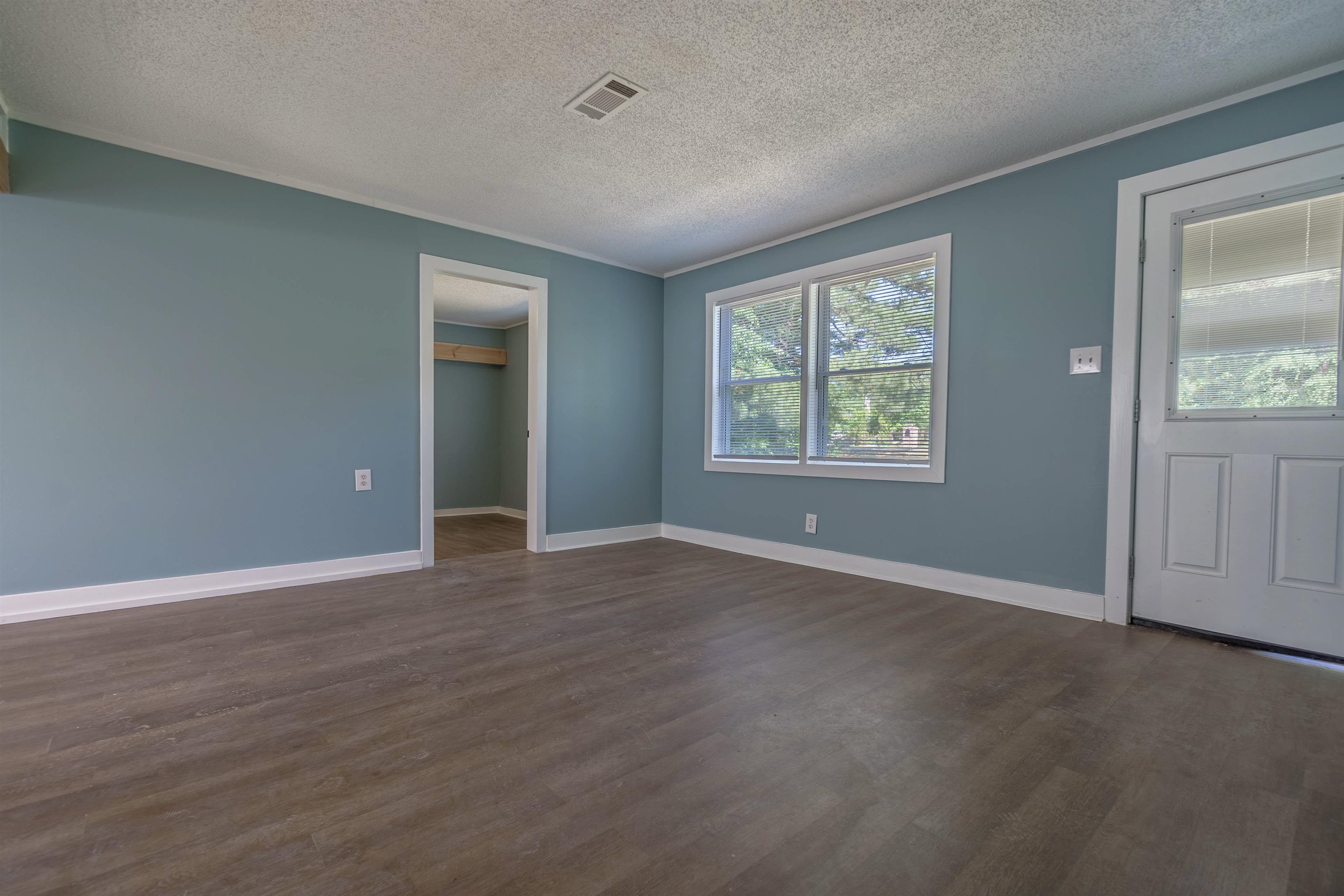 2631 Berryhill Road Memphis, TN 38016 - Photo 16 of 17 a view of an empty room with wooden floor and a window