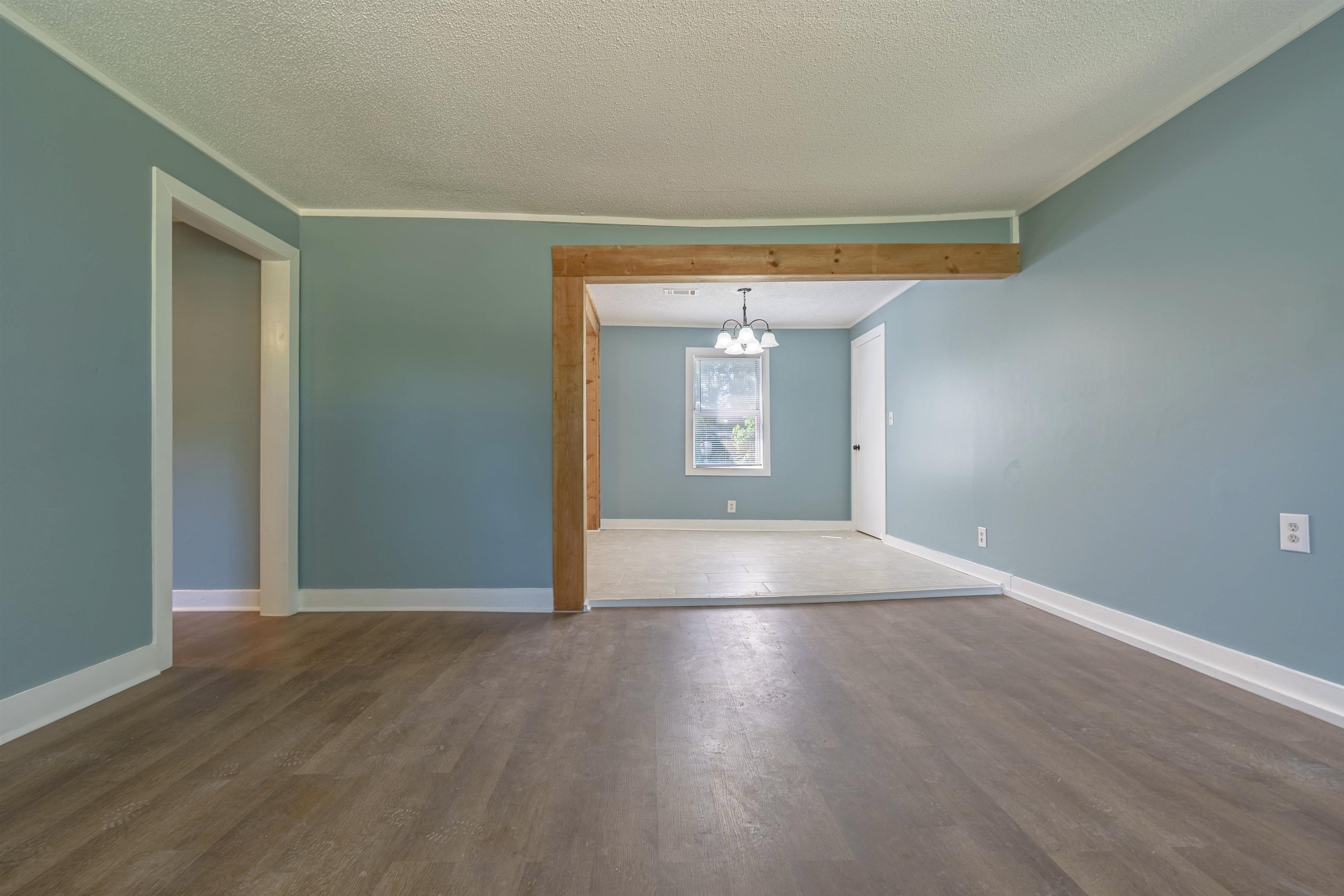 2631 Berryhill Road Memphis, TN 38016 - Photo 8 of 17 a view of an empty room with wooden floor and a window
