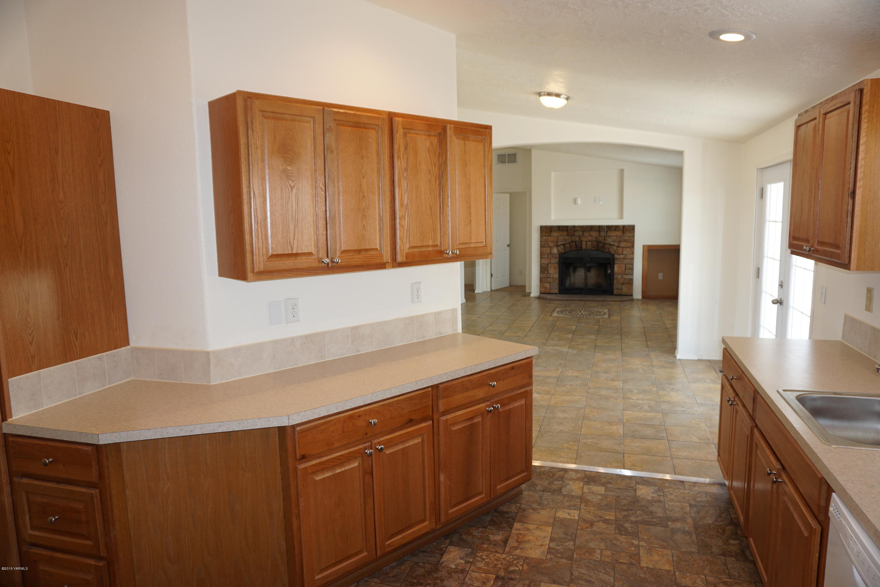 11785 Postma Road Moxee, WA 98936 - Photo 8 of 22 a kitchen with sink cabinets and fireplace