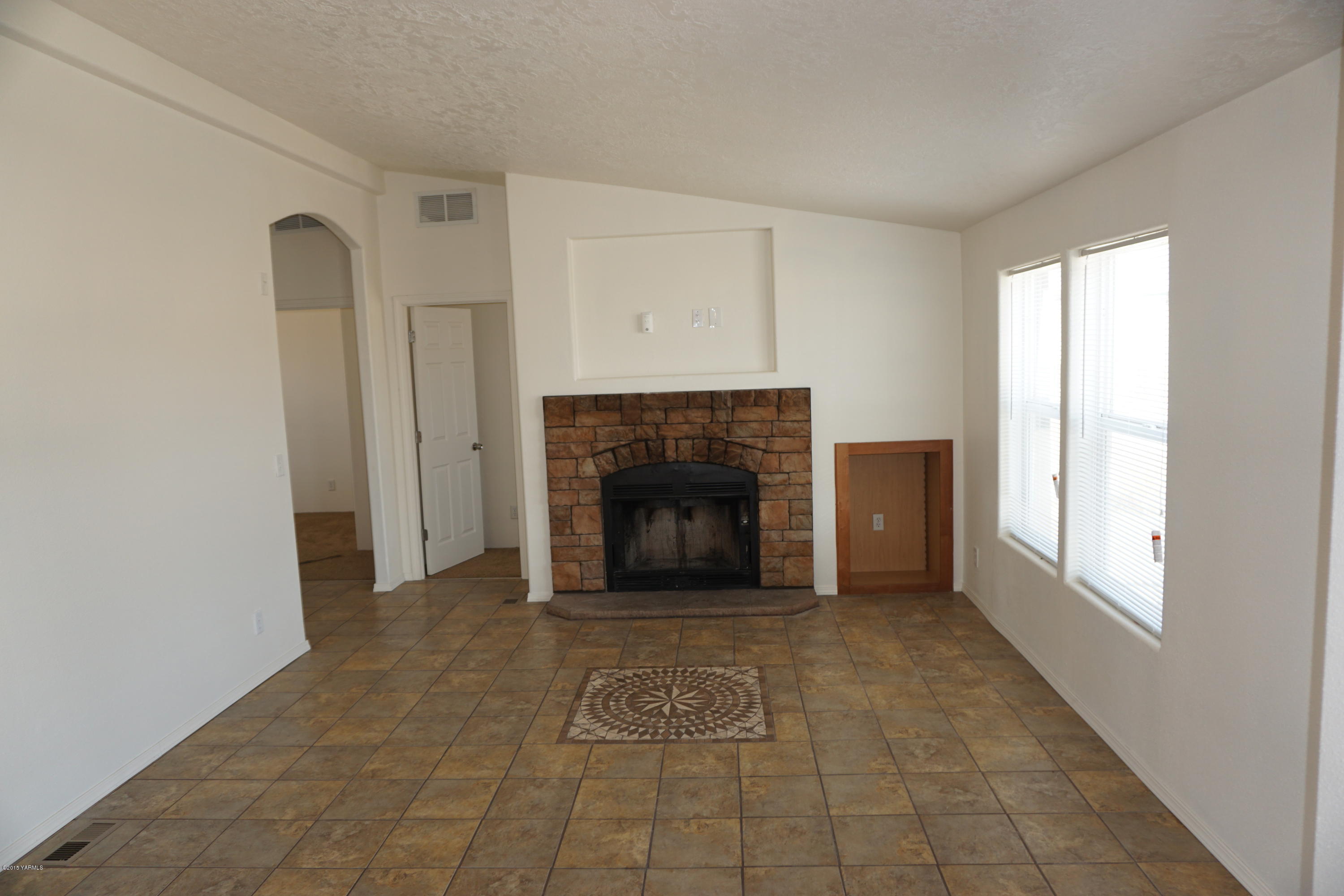 11785 Postma Road Moxee, WA 98936 - Photo 9 of 22 a view of a livingroom with a fireplace and window